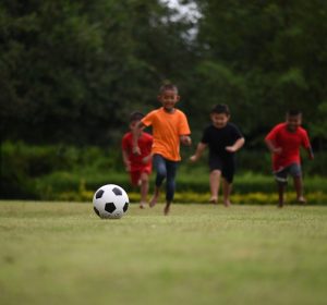 Kids playing soccer football